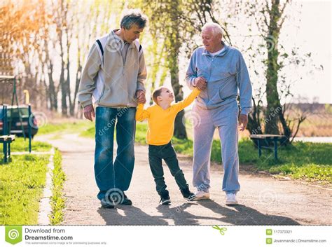 Two Grandfather Walking With The Grandson In The Park Stock Image Image Of Male Walk 117370321