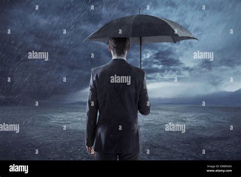 Depressed Businessman Standing With An Umbrella Stock Photo Alamy