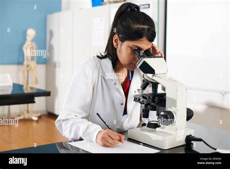 Chemistry Student Using Microscope In Laboratory Stock Photo Alamy