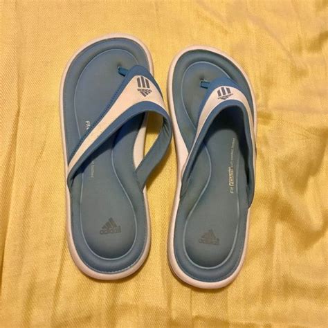 The slide sandals' upper straps usually feature a graphic, most likely an adidas triple stripe brand logo. I just discovered this while shopping on Poshmark: Adidas ...