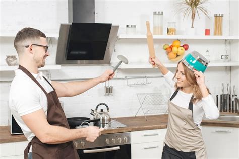 Free Photo Couple Having Fun Fight In Kitchen