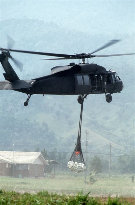 A Uh 60 Black Hawk Blackhawk Helicopter Carries A Cargo Sling During