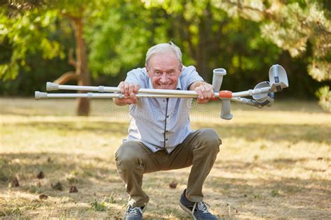 Old Man With Vitality And Crutches Stock Photo Image Of Active Flexible 87469590