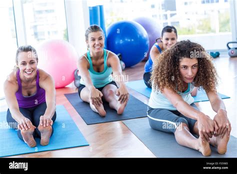 Woman Sitting In Forward Bend Pose Stock Photo Alamy