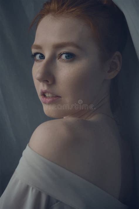 Redhead Girl Looking At The Camera Over Her Naked Shoulder Frame