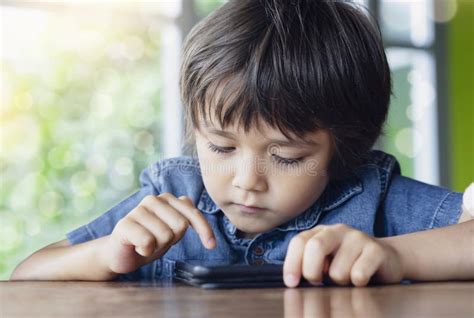 Selective Focus Of Toddler Boy Playing Game On Smart Phonekid Boy