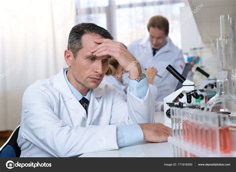Stressed scientist in lab Stock Photo by ©VitalikRadko 171918350