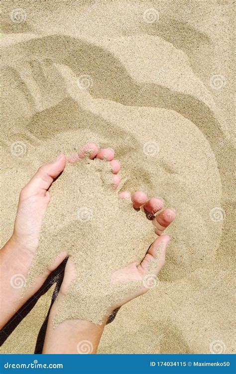 female hand pours sand through his fingers on seashore stock image image of summertime