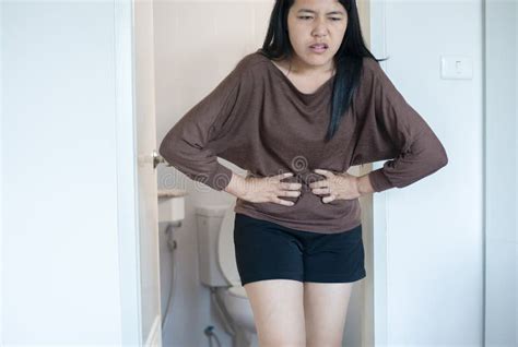 Asian Woman Having Painful Stomachache And Diarrhea In Front Of Toilet