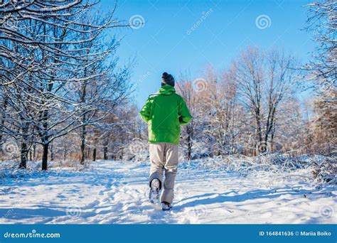 Running Athlete Man Sprinting In Winter Forest Training Outside In