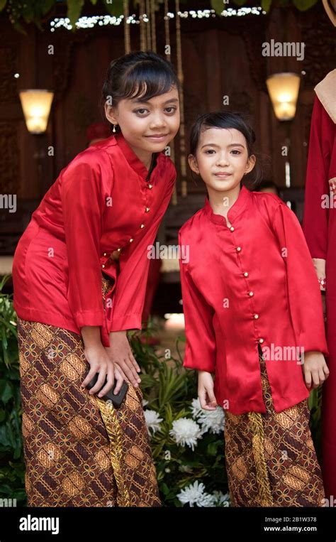 little indonesian girls in traditional red dress at a traditional indonesian wedding in jakarta