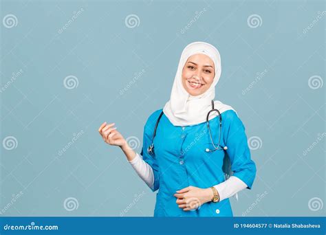 Portrait Of A Friendly Muslim Doctor Or Nurse Woman In Hijab With A Stethoscope On A Blue