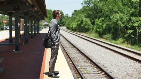 Video Of A Business Man Walking On A Railroad Track At The Middle Of
