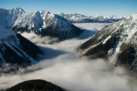 Rocky Mountain With Fog In Daytime Photo · Free Stock Photo