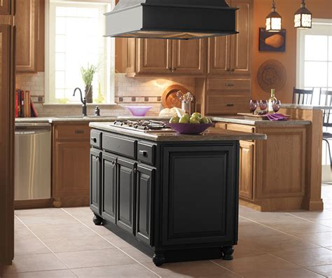 The design house claremont two door bath cabinet exhibits fine craftsmanship with its antique brass town square style cabinet hardware included. Light Oak Cabinets with a Black Kitchen Island - MasterBrand