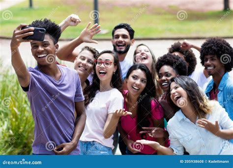 Large Group Of Multi Ethnic Young Adults Taking Crazy Selfie With Phone