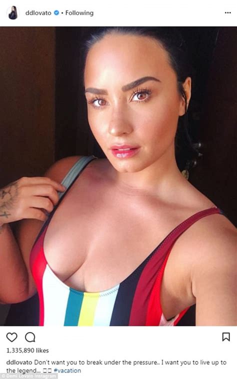 Demi Lovato Showcases Her Assets In Plunging Striped Bathing Suit