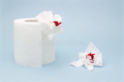 A Photo Of A Toilet Paper Roll And Two Used Bloody Toilet Paper Sheets