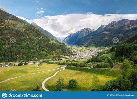 Idyllic Landscape In The Alps With Fresh Green Meadows And Blooming