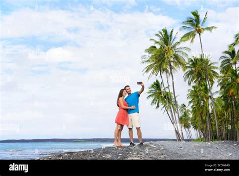 Selfie Couple On Hawaii Beach Vacation With Palm Trees And Volcanic