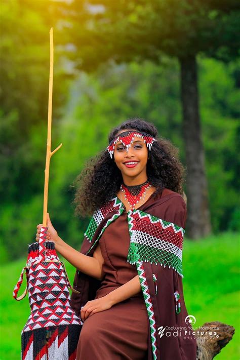 A Woman In Native Dress Holding An Umbrella