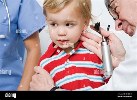 Doctor Examining Senior Patients Ear Hi Res Stock Photography And