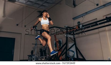 Female Athlete With Motion Capture Sensors On Her Body Running In Biomechanical Lab Recording