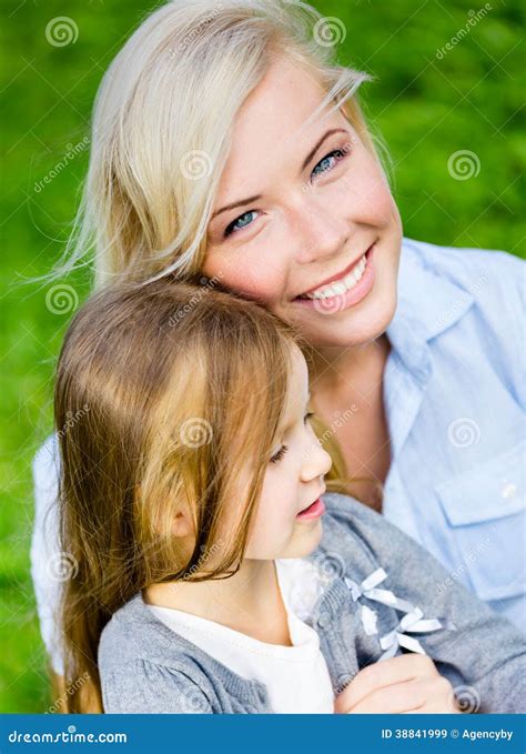Mother And Daughter Embrace Each Other On The Grass Stock Image Image Of Glad Attractive