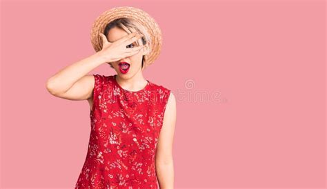 Young Beautiful Blonde Woman Wearing Summer Hat Peeking In Shock Covering Face And Eyes With