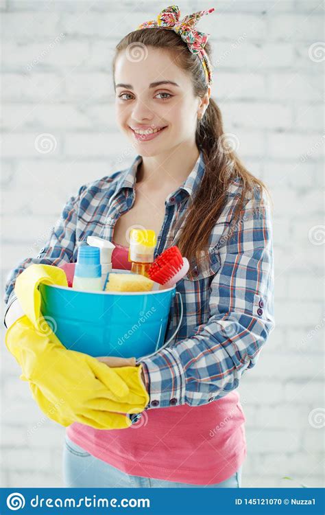 Beautiful And Young Woman Doing The Cleaning At Home Stock Photo