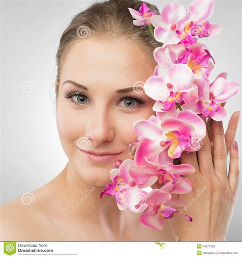 Beautiful Girl Holding Orchid Flower In Her Hands Stock Photo Image