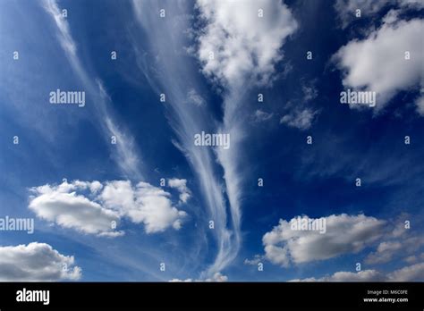Cirrus Clouds And Cumulus Humilis Clouds In A Deep Blue Sky Stock Photo
