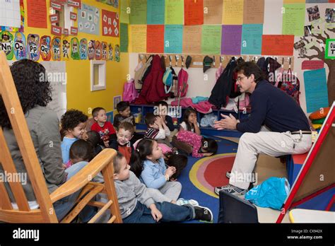 Male Preschool Teacher Talking To His Class Stock Photo Alamy