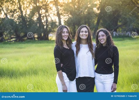 Outdoor Portrait Of Three Beautiful Hispanic Women Standing Together Outdoors Stock Image