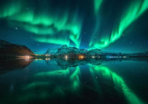 Northern Lights Over Snowy Mountains Sea Reflection In Water Stock