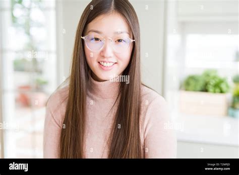 beautiful asian woman wearing glasses with a happy and cool smile on face lucky person stock