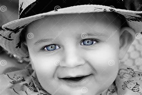 The A Young Baby Is In Black And White With Bright Blue Eyes Use It
