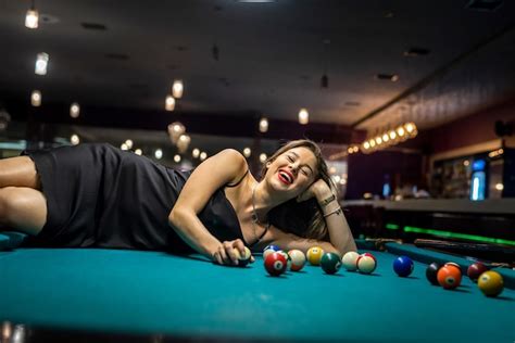 Premium Photo Sexy Female Pool Player Wear Black Dress Lying On Billiard Table