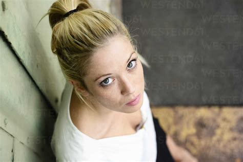 Portrait Of Young Woman Looking Up To Camera Stock Photo