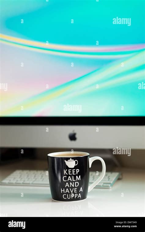 Keep Calm And Have A Cuppa Tea On A Computer Desk Stock Photo Alamy