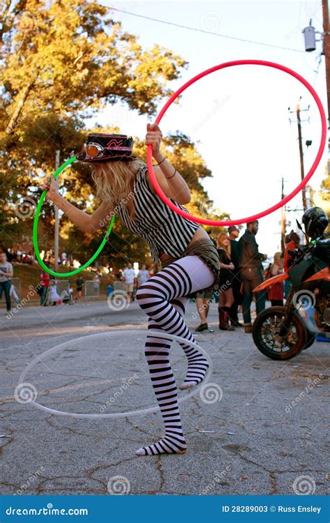 Female Street Performer Entertains With Three Hula Hoops Editorial