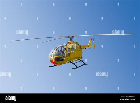 Flying Yellow Rescue Helicopter And Blue Sky Stock Photo Alamy