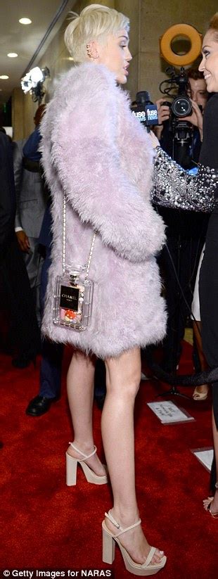 miley cyrus wraps up in lilac fur coat at the pre grammy clive davis party but still shows