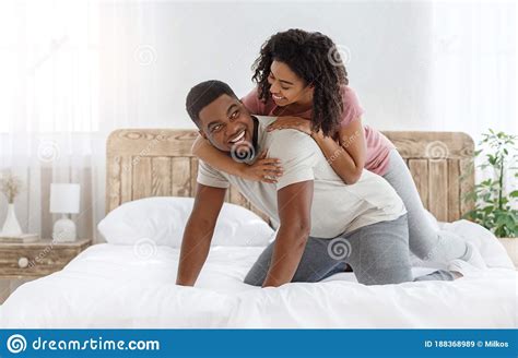 Young Loving African Couple Having Romantic Times In Bedroom Stock