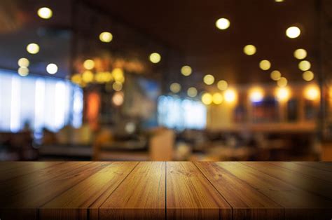 Empty Wooden Table Top With Blur Coffee Shop Or Restaurant Interior