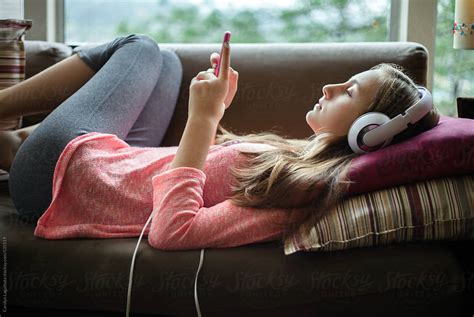 Teenage Girl Relaxing And Listening To Music At Home By Stocksy Contributor Carolyn Lagattuta