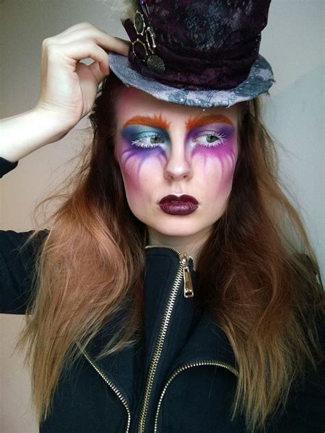 A Woman With Makeup Is Wearing A Top Hat