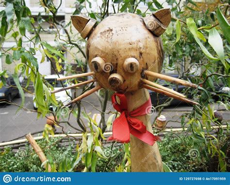 Interesting Wooden Sculpture Of A Cat With A Red Bow On