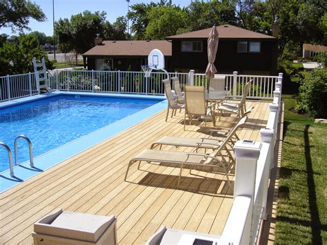 Above ground pools with decks are popular in coastal areas where sand makes an underground pool difficult to build. The How To Choose Above Ground Pool Decks Wooden photo