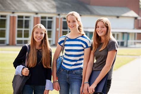 Group Of Female Teenage Students Walking Around College